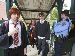 In this Oct. 18, 2014, photo, students from Chestnut Hill College in Philadelphia wear costumes to attend an annual festival based on the Harry Potter fantasy series conceived by British author J.K. Rowling, including Dan Lemoine, second from right, dressed as the title character; Mollie Durkin, second from left, dressed as the character Hermione Granger; and John Spiewak Jr., left, dressed as the character Ron Weasley, as they arrive at the festival in the Chestnut Hill neighborhood of Philadelphia. In 2018,