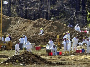 In this Sept. 16, 2001, file photo, FBI investigators continue excavating the crash site of United Flight 93 in Shanksville, Pa.