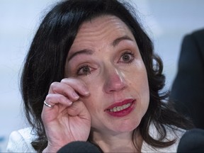 Martine Ouellet wipes a tear during a news conference in Montreal on Monday, June 4, 2018. Ouellet announced she is stepping down as head of the Bloc Quebecois after a resounding defeat in a weekend leadership vote. (The Canadian Press/Paul Chiasson)
