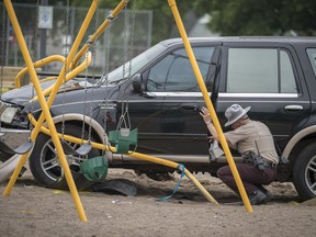 Minnesota State Patrol investigates the scene where a motorist being pursued by the State Patrol veered into a Minneapolis school playground Monday, June 11, 2018. At least two young children suffered life-threatening injuries after police say a motorist being pursued by the State Patrol veered into a Minneapolis park and struck them. The State Patrol says the driver ran from the crash scene and was arrested.