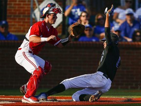 Kentucky's Tristan Pompey (6) scores as North Carolina State catcher Andy Cosgrove waits for the ball during an NCAA tournament regional game in Lexington, Ky., Saturday, June 3, 2017. (THE CANADIAN PRESS/AP, Alex Slitz, Lexington Herald-Leader)