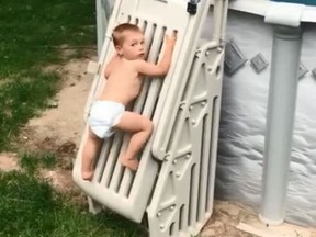 In a viral video, 2-year-old Cody Wyman scales a previously un-climbable pool lader. (Facebook)