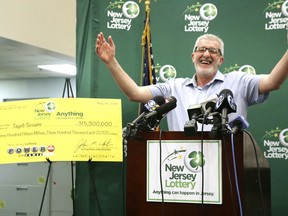 Tayeb Souami, of Little Ferry, gestures as he iss introduced as the $351.3 million Powerball winner, Friday, June 8, 2018, in Trenton, N.J.