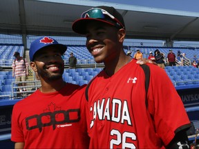 Dalton Pompey congratulates his little brother Tristan Pompey after the Toronto Blue Jays played the Canadian Jr. Team in Dunedin, Florida  on Sunday March 15, 2015. (Stan Behal/Toronto Sun)
