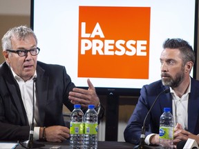 La Presse publisher Guy Crevier, left, responds to a question as president Pierre-Elliott Levasseur looks on during a news conference Tuesday, May 8, 2018 in Montreal. (The Canadian Press/Paul Chiasson)