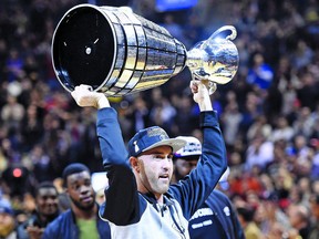 This is how Ricky Ray’s career should be remembered, hoisting the Grey Cup for a fourth time last November, not being carted off with a serious neck injury. Nathan Denette/The Canadian Press