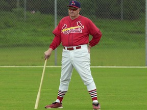 In this Feb. 21, 2002, file photo, Red Schoendienst stands in center field in Jupiter, Fla., with his fungo bat, watching practice for the St. Louis Cardinals during spring training