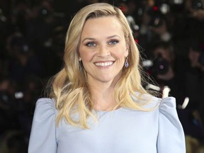 FILE - In this March 13, 2018, file photo, Actress Reese Witherspoon poses for photographers upon arrival at the premiere of the film 'A Wrinkle In Time' in London. Witherspoon confirms there will be a "Legally Blonde 3." The actress on Thursday, June 7, 2018, posted a video on Instagram of her floating in a pool wearing a pink bikini. The caption read: "It's true...(hash) LegallyBlonde3."