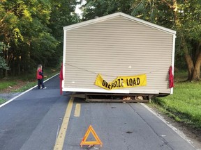 This June 26, 2018 photo provided by the Dover Delaware Police Department shows a prefabricated home that was abandoned on a roadway in Dover, Del. Dover Police Department said someone left the home on a two-lane road and no one was available to move it until Wednesday, June 27. (Dover Delaware Police Department via AP)