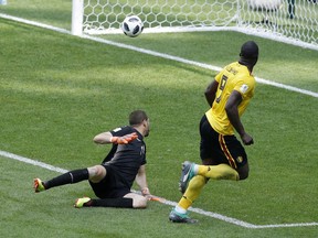 Belgium's Romelu Lukaku, right, scores his side's third goal against Tunisia during the Group G action against Tunisia at the 2018 World Cup at Spartak Stadium in Moscow, Russia, Saturday, June 23, 2018.