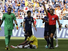 Referee Damir Skomina from Slovenia shows the red card to Colombia's Carlos Sanchez, bottom, during the Group H match between Colombia and Japan at the 2018 soccer World Cup in the Mordavia Arena in Saransk, Russia, Tuesday, June 19, 2018.