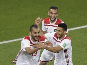Morocco's Khalid Boutaib, left, celebrates after scoring his side's first goal during the group B match against Spain at the 2018 World Cup in the Kaliningrad Stadium in Kaliningrad, Russia, Monday, June 25, 2018.
