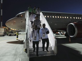 In this photo taken on late Monday, June 18, 2018, Saudi Arabian soccer team disembark the plane upon their arriving at the Rostov-on-Don airport, Russia.