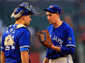 Blue Jays' Luke Maile talks with Aaron Sanchez during the first inning against the Los Angeles Angels of Anaheim at Angel Stadium on June 21, 2018 in Anaheim, California. (GETTY IMAGES)