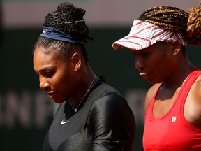 Venus Williams and Serena Williams in conversation during their ladies doubles match against Andreja Klepac and Maria Jose Martinez Sanchez at Roland Garros on June 3, 2018