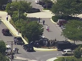 In this frame from video, people leave the Capital Gazette newspaper after multiple people were shot on Thursday, June 28, 2018, in Annapolis, Md.