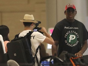Former NBA basketball player Dennis Rodman arrives at Singapore's Changi Airport on Tuesday, June 12, 2018.