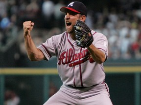 In this Oct. 10, 2004, file photo, Atlanta Braves' John Smoltz reacts as Houston Astros' Lance Berkman, background, walks off the field during after the final out of their National League Division Series Game 4, to even the series at 2 games apiece, in Houston