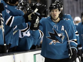In this April 3, 2018 file photo, San Jose Sharks' Logan Couture celebrates his goal with teammates during the first period of an NHL hockey game against the Dallas Stars in San Jose, Calif.