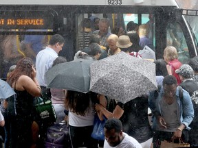 Transit riders try to enter shuttle buses at Yonge and Bloor as parts of both Lines 1 and 2 were closed on Monday June 18, 2018. Dave Abel/Toronto Sun