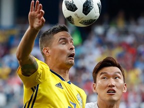 Sweden's Mikael Lustig, left, and South Korea's Jang Hyun-soo battle for the ball during the group F match between Sweden and South Korea at the 2018 soccer World Cup in the Nizhny Novgorod stadium in Nizhny Novgorod, Russia, Monday, June 18, 2018.