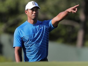 Tiger Woods motions while chipping onto the third green during a practice round for the U.S. Open Golf Championship on June 12, 2018, in Southampton, N.Y.