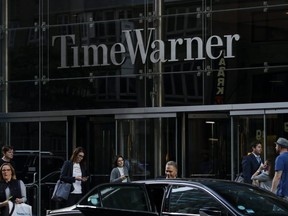 People walk past the Time Warner Center in New York City on Tuesday, June 12, 2018.