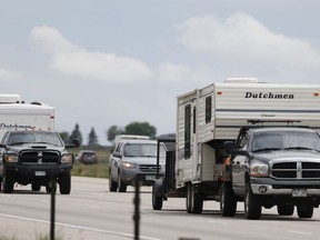 FILE - In this May 27, 2016, file photo, motorists guide their vehicles northbound on Interstate 25 to mark the start of the Memorial Day weekend near Firestone, Colo. Suddenly road trips are trendy again. Surveys from MMGY, Ford and AAA show their popularity is up. Websites, newspapers, magazines and even books are featuring road trips like they're the next big thing _ even though they're actually a longstanding American tradition.