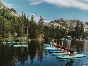 This July 24, 2017 photo provided by Wanderlust, participants work out on paddle boards during Wanderlust Squaw Valley 2017, in North Lake Tahoe, Calif. Wellness tourism is booming, with travelers not just staying fit while on the road, but planning entire trips with a goal of improving their health and well-being.