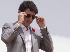 Prime Minister Justin Trudeau removes his sunglasses as he arrives in Ho Chi Minh City, Vietnam on Thursday November 9, 2017. Trudeau was forced to pay a $100 fine for violating conflict of interest rules by not disclosing a gift given to him last year by P.E.I. Premier Wade MacLauchlan.THE CANADIAN PRESS/Adrian Wyld
