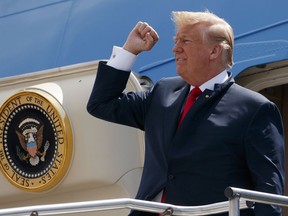 President Donald Trump pumps his fist as he steps off Air Force One after arriving at Ellington Field Joint Reserve Base, in Houston on May 31, 2018. (AP Photo/Evan Vucci)
