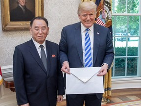 U.S. President Donald Trump (left) poses with North Korean official Kim Yong Chol, after receiving a letter from North Korea's leader Kim Jong Un.