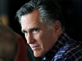 In this March 3, 2018, file photo, Mitt Romney speaks with a group during a breakfast campaign stop in Green River, Utah.