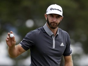 Dustin Johnson reacts after making a putt for birdie on the fourth green during the second round of the U.S. Open Golf Championship, Friday, June 15, 2018, in Southampton, N.Y.