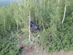 A car that crashed off a mountain road in northern Utah and landed in a tree, injuring seven teenagers from the Ogden area on Thursday, June 14, 2018, is pictured in this photo provided by the Weber County Sheriff's Office. (Weber County Sheriff's Office via AP)