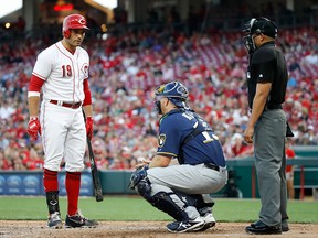 Joey Votto of the Cincinnati Reds and Erik Kratz of the Milwaukee Brewers exchange words during the third inning at Great American Ball Park on June 28, 2018 in Cincinnati. (Andy Lyons/Getty Images)