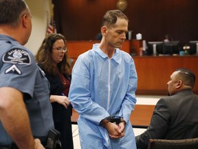 In this Nov. 3, 2017, file photo, Scott Ostrem, 47, centre, leaves a hearing in Brighton, Colo.