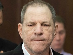 In this May 25, 2018 file photo, Harvey Weinstein, centre, listens during a court proceeding in New York during his arraignment on rape and other charges.