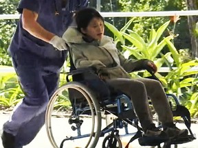 In this photo taken from the Australian Broadcasting Corporation video, South Korean backpacker Joohee Han, 25, is wheeled  to a hospital after being rescued by helicopter, Thursday, June 7, 2018, in Tully, Queensland, Australia. (AP)