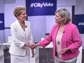 Ontario Liberal Premier Kathleen Wynne, left, and NDP Leader Andrea Horwath shake hands at the Ontario Leaders debate in Toronto on Monday, May 7, 2018. This is the first of three debates scheduled before the June 7 vote.