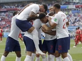 England players run to teammate John Stones after he scored his team's first goal during the Group G match against Panama at the 2018 World Cup at Nizhny Novgorod Stadium in Nizhny Novgorod, Russia, Sunday, June 24, 2018.