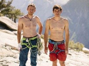 In this June 3, 2018 photo provided by Corey Rich, Alex Honnold, right, and Tommy Caldwell pose for a portrait at the top of El Capitan in Yosemite National Park, Calif. Days after two of the world's most celebrated rock climbers twice set astonishingly fast records on the biggest wall in Yosemite National Park, they did it again Wednesday, June 6, 2018, breaking a mark compared with track's four-minute mile.