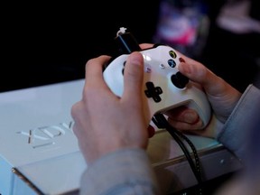 A gamer plays video games with a Xbox console during the 2017 Paris Games Week exhibition at the Porte de Versailles exhibition centre in Paris on Nov. 5, 2017. (Thomas Samson/Getty Images)