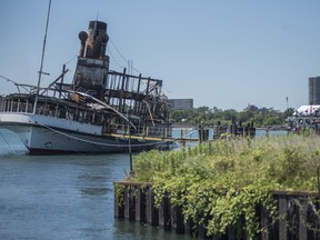 The SS Ste. Claire lists port side after catching fire at Detroit's Riverside Marina on Friday, July 6, 2018.  (Ben Allan Smith/Ann Arbor News via AP)