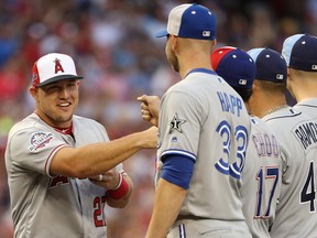 Mike Trout of the Los Angeles Angels of Anaheim fist pumps the Blue Jays' J.A. Happ on Tuesday night at the all-star game in Washington. Photo by Patrick Smith/Getty Images