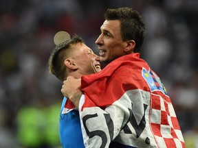 Croatia's Mario Mandzukic (right) celebrates with assistant coach Ivica Olic after beating England on Wednesday. (GETTY IMAGES)