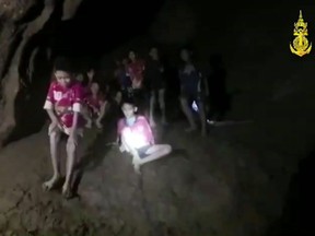In this grab taken from video provided by the Thai Navy Seal, a view of the boys and their soccer coach as they are rescued in a cave, in Chiang Rai in Thailand, Monday, July 2, 2018.  (Thai Navy Seal via AP)