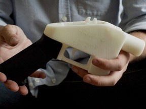 Cody Wilson holds what he calls a Liberator pistol that was completely made on a 3-D-printer at his home in Austin, Texas, on May 10, 2013.