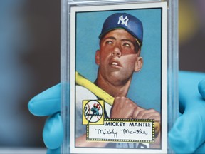 The "Holy Grail" of baseball cards, a 1952 Topps Mickey Mantle that is valued at more than $10 million, is put on display as part of baseball memorabilia exhibit at the Colorado History Museum Monday, July 16, 2018, in Denver. (AP Photo/David Zalubowski)