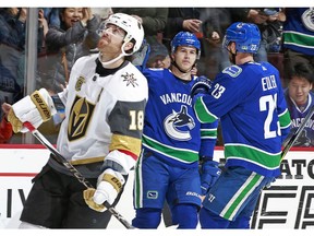 James Neal #18 of the Vegas Golden Knights looks on as Nikolay Goldobin #77 of the Vancouver Canucks is congratulated by teammate Alexander Edler #23 after scoring during their NHL game at Rogers Arena April 3, 2018 in Vancouver, British Columbia, Canada.